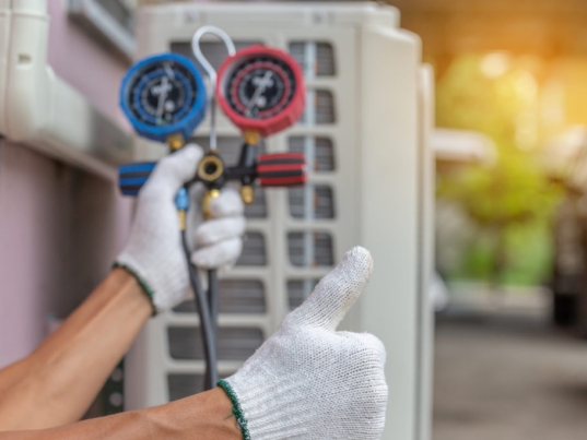 Close up of Air Conditioning Repair, repairman on the floor fixing air conditioning system